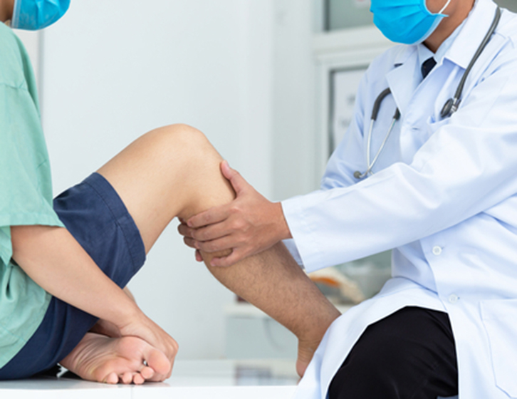 Doctor examining patient's knee - Pain Management